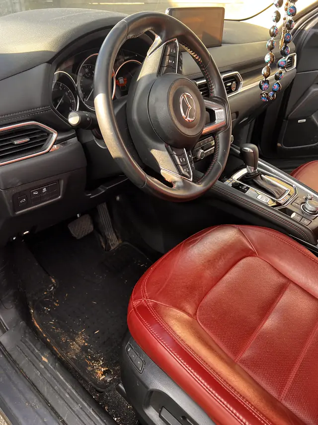 Mazda CX-5 driver side before: dirt and debris on the floor mat.