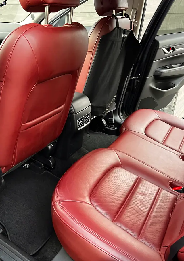 The Mazda CX-5's rear seats after the detail: clean red leather and spotless black carpet.